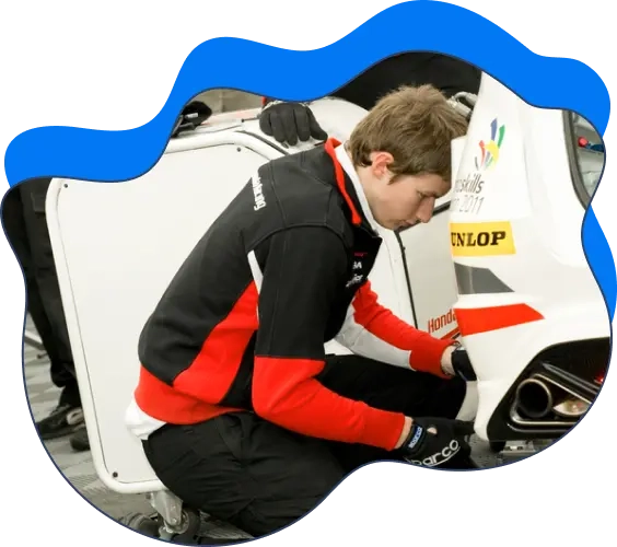 A mechanic fixing a race car